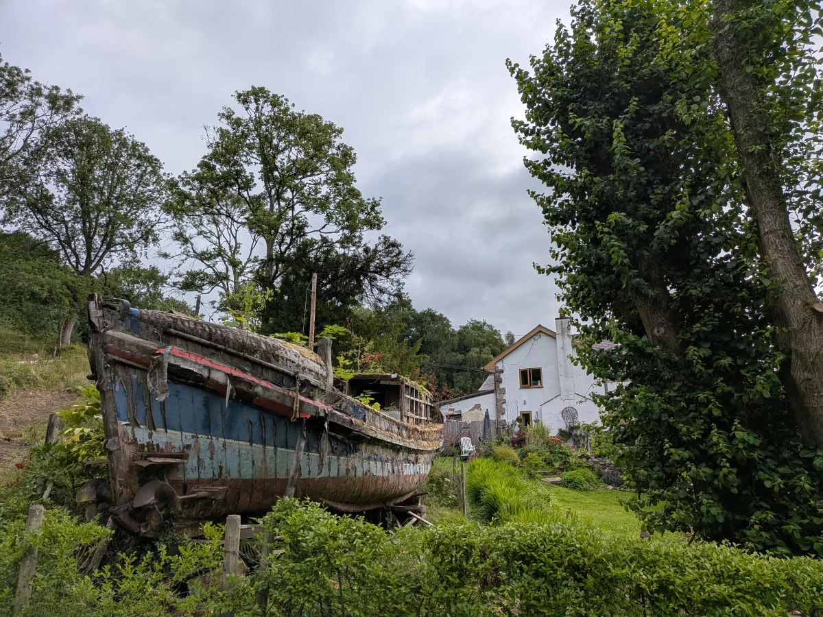 Beautiful house with an old canal boat in the garden.